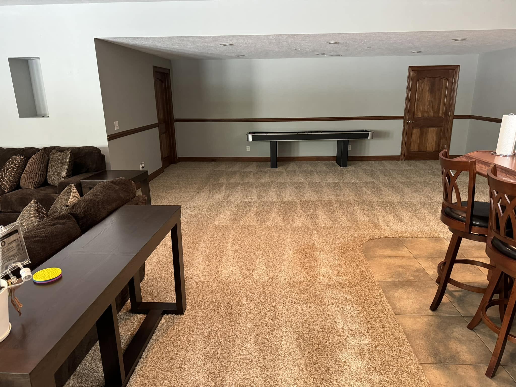 Freshly cleaned living space with visible vacuum lines